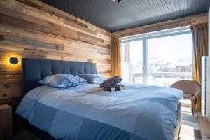 a teddy bear sitting on a bed in a bedroom at Beautiful flat in L'Alpe d'Huez heart at the foot of the slopes - Welkeys in LʼHuez