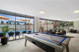 a pool table in a room with a swimming pool at Casablanca In Landmark Resort in Nelson Bay