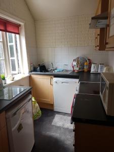 a kitchen with a sink and a counter top at Jolly Sailor in Cawood