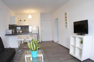 a living room with a couch and a table at Margarita Napa Apartments in Ayia Napa