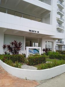 a white building with a sign in front of it at Aqualina Green Girardot in Girardot +10 photos