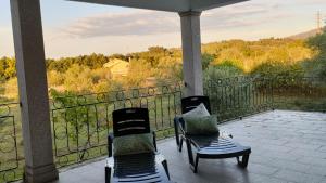 two chairs on a porch with a view of the mountains at Quinta da Barbosa in Folgosinho