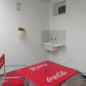 a cocacola sign on a table in a room at La casita in Paraná
