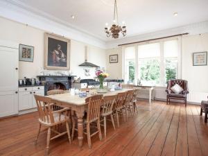 a kitchen and dining room with a table and chairs at Longcroft House in Torquay