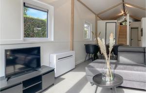 a living room with a couch and a tv at Stunning Home In Putten With Wifi in Putten