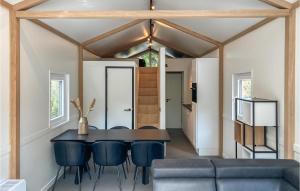 a dining room with a black table and blue chairs at Stunning Home In Putten With Wifi in Putten