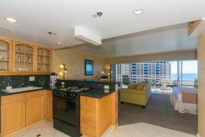 a kitchen with a living room and a bedroom at Ilikai Tower 1918 Lagoon View 1BR in Honolulu