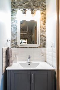a bathroom with a sink and a mirror at The Inn on Bay in Gravenhurst