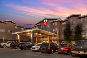 a hotel parking lot with cars parked in front of it at Best Western PLUS Fort Saskatchewan Inn & Suites in Fort Saskatchewan