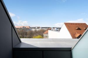 a view from the balcony of a white building with a roof at elaya hotel leipzig city center in Leipzig
