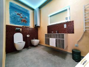 a bathroom with a toilet and a sink at Luxury Resort Hostess in Dej