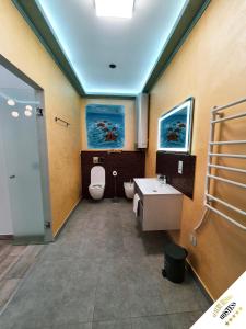 a bathroom with a toilet and a sink at Luxury Resort Hostess in Dej