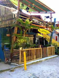 a store with a palm tree in front of a building at Pousada Maravilha Itacaré in Itacaré