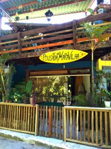 a surfboard sitting on the side of a building at Pousada Maravilha Itacaré in Itacaré