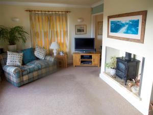 a living room with a couch and a television at Town View in Burneside