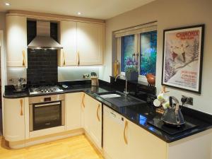 a kitchen with a stove and a counter top at Town View in Burneside