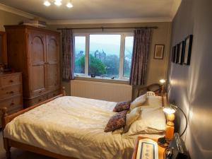 a bedroom with a bed and a window at Town View in Burneside