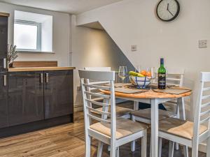 a kitchen and dining room with a table and chairs at Chuckle Cottage in Braunton