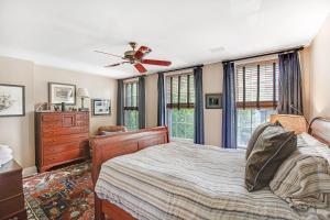 a bedroom with a bed and a ceiling fan at Submariners Gate in Annapolis
