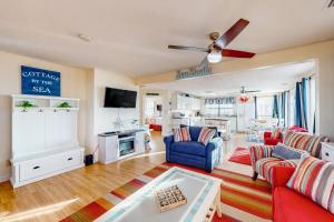a living room with a red couch and a blue chair at Island Palms in St. George Island