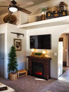 a living room with a fireplace and a flat screen tv at Pine Ridge - Memories are made here! in Florissant