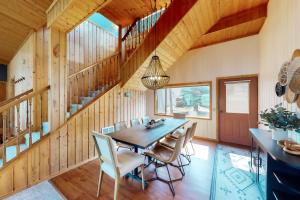 a dining room with a table and chairs and a staircase at Lakeside Landing in Hope