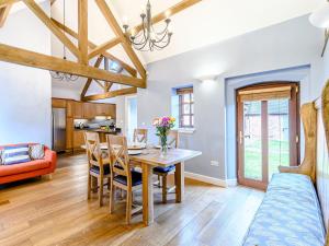 a kitchen and dining room with a table and chairs at Low Barn in Market Bosworth