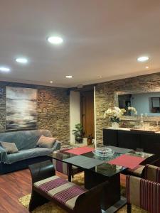 a living room with a table and a couch at Casa do Soto in Milhão