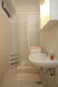 a bathroom with a sink and a shower at Rooms by the sea Medveja, Opatija - 7775 in Lovran