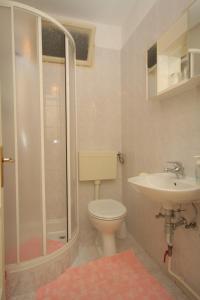 een badkamer met een douche, een toilet en een wastafel bij Double Room Medveja 7775d in Lovran