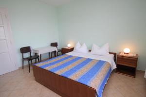 a bedroom with a bed and a table and chairs at Double Room Medveja 7775c in Lovran