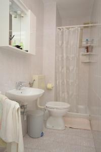 a bathroom with a toilet and a sink and a shower at Double Room Medveja 7775c in Lovran