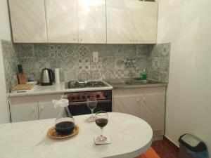 a kitchen with two glasses of wine on a table at Apartments with a parking space Zavala, Hvar - 8706 in Jelsa