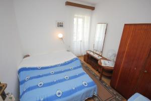 a bedroom with a bed and a dresser in it at Apartments by the sea Vis - 2477 in Vis