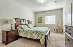 a bedroom with a bed and a dresser and a window at 1-Bedroom Condo in the Heart of the City in Salt Lake City