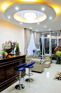 a living room with blue stools in a lobby at Lotus Apartment Hotel in Vung Tau