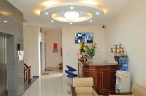 a hospital hallway with a waiting room with a waiting chair and a ceiling at Lotus Apartment Hotel in Vung Tau
