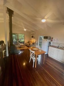 a kitchen and living room with a table and a kitchen and a dining room at Kondalilla Eco Resort in Montville