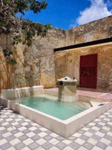 a large pool of water in a courtyard at MELISA HOSTAL in Campeche
