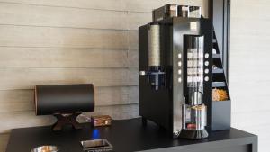 a coffee machine sitting on a black desk at JR-East Hotel Mets Tokyo Bay Shinkiba in Tokyo