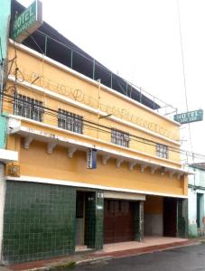 un edificio amarillo con un cartel en el costado en Hotel Landivar Zona 7, en Guatemala