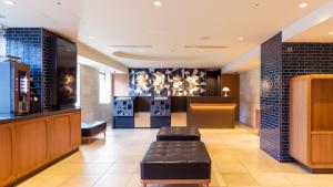 a lobby with a waiting room with a couch and a bar at JR-East Hotel Mets Akabane in Tokyo +98 photos