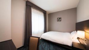 Säng eller sängar i ett rum på JR-East Hotel Mets Kawasaki