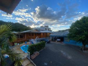 a house with a car parked in front of a driveway at Casa hotel in Barra do Guarita