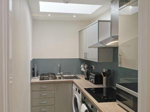 a kitchen with a sink and a stove top oven at Bell Tower in Berwick-Upon-Tweed