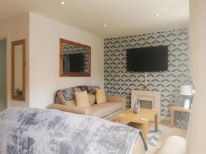 a living room with a bed and a tv at Bell Tower in Berwick-Upon-Tweed