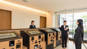Tre donne in piedi in una stanza con scatole di JR-East Hotel Mets Yokohama Sakuragicho a Yokohama