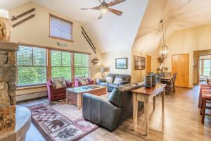 a living room with a couch and a table at Jackpine Lodge by Summit County Mountain Retreats in Keystone