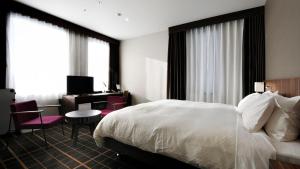 Postel nebo postele na pokoji v ubytování JR-East Hotel Mets Utsunomiya