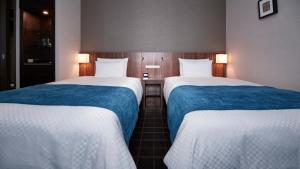 Postel nebo postele na pokoji v ubytování JR-East Hotel Mets Utsunomiya